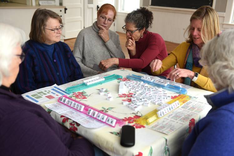Cindy De Santis, left, of Monroe, N.H., and Robin Wagner, of North Thetford, Vt., observe a game of mahjong on Tuesday, March, 26, 2024, in Thetford. It was De Santis' first time playing the game. After teaching a class about the game at the library, Wagner has organized a weekly drop in of the game at the Thetford Community Center. Playing are Janice Mousley, of East Thetford, left, Merit Scotford, of Post Mills, Vt., Joanne Egner, of Norwich, Vt and Ann Kearney, of Thetford, Center. (Valley News - Jennifer Hauck) Copyright Valley News. May not be reprinted or used online without permission. Send requests to permission@vnews.com.