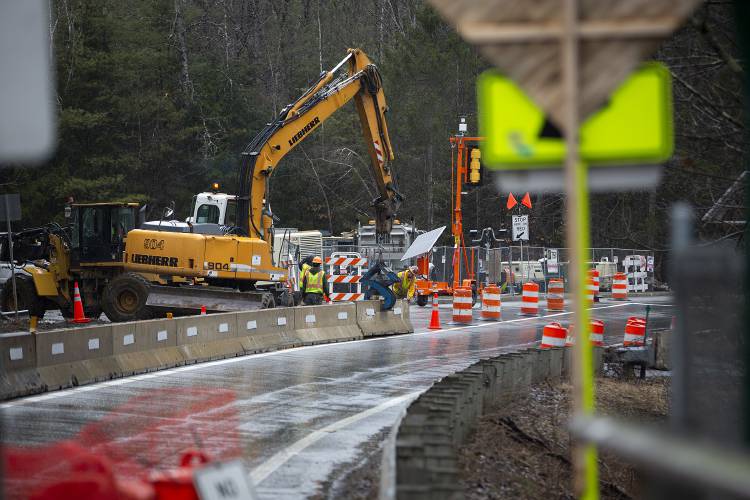 A crew from Harrison and Burrowes Bridge Constructors places barriers to separate the east and westbound lanes on Route 4, limiting traffic to one side of the road to make room for construction on the Quechee Gorge Bridge in Quechee, Vt., on Wednesday, April 10, 2024. Traffic on the bridge will be limited to one lane from April through November each year until the completion of the project, which the Vermont Agency of Transportation estimates will happen in June 2026. (Valley News / Report For America - Alex Driehaus) Copyright Valley News. May not be reprinted or used online without permission. Send requests to permission@vnews.com.