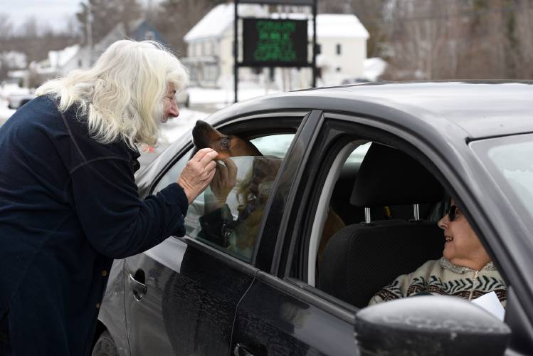 Julie Tatem pets Katurah the dog outside the Canaan, N.H., polls while Barbara Buzzell waits in the car after voting on Tuesday, Jan. 23, 2024. Buzzell voted for Donald Trump and Tatem cast her ballot for Robert F. Kennedy Jr. in the New Hampshire Primary. (Valley News - Jennifer Hauck) Copyright Valley News. May not be reprinted or used online without permission. Send requests to permission@vnews.com.