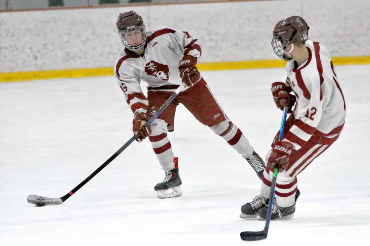 Hanover High's Andrew Rudd, left, prepares to pass to Jack Wilkinson during a 5-4 defeat of NHIAA Division I foe Nashua North-Souhegan on Feb. 14, 2024, at Campion Rink in West Lebanon, N.H. Rudd was whistled for three of his team's 11 penalties and the visitors had an equal amount during a game that lasted 2 1/2 hours. (Valley News - Tris Wykes) Copyright Valley News. May not be reprinted or used online without permission.