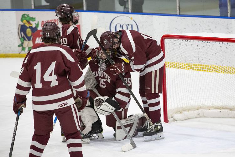 Hanover’s Trevor Sanders (17), Ronan Przydzieklski (10) and Tyler Gammell (14) console goaltender Jo Jo Drent (35) after losing the NHIAA D-I boys hockey semifinal game against Windham at JFK Memorial Coliseum in Manchester, N.H., on Wednesday, March 6, 2024. Windham won, 5-1. (Valley News / Report For America - Alex Driehaus) Copyright Valley News. May not be reprinted or used online without permission. Send requests to permission@vnews.com.