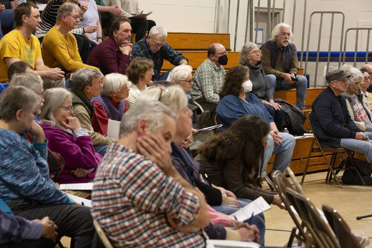 Joyce Dion, left, and George Ostler, center, rest their heads in their hands while listening to the board’s response to a question about last year’s budget surplus asked by Alex Bird, top right, during the Annual School Meeting at Sharon Elementary School in Sharon, Vt., on Monday, March 4, 2024. Following changes to Act 127, the school board moved to amend their proposed budget from the floor, eliminating a $475,000 one-time expenditure. (Valley News / Report For America - Alex Driehaus) Copyright Valley News. May not be reprinted or used online without permission. Send requests to permission@vnews.com.