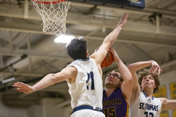 Mascoma forward Tyler-Jay Mardin (15) shoots the ball while being defended by St. Thomas Aquinas forwards William Mollica (21) and Carson Couperthwait (23) during the NHIAA Division III boys basketball semifinal game held at Bow High School in Bow, N.H., on Tuesday, Feb. 20, 2024. (Valley News / Report For America - Alex Driehaus) Copyright Valley News. May not be reprinted or used online without permission. Send requests to permission@vnews.com.