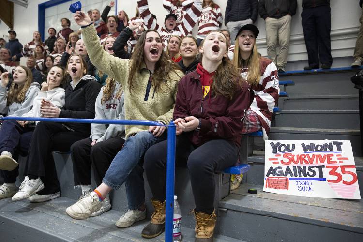 Members of the Hanover girls hockey team, from left, Hannah Gardner, Rachel Rockmore and Eleanor Edson cheer from the stands during the NHIAA D-I boys hockey semifinal game at JFK Memorial Coliseum in Manchester, N.H., on Wednesday, March 6, 2024. (Valley News / Report For America - Alex Driehaus) Copyright Valley News. May not be reprinted or used online without permission. Send requests to permission@vnews.com.
