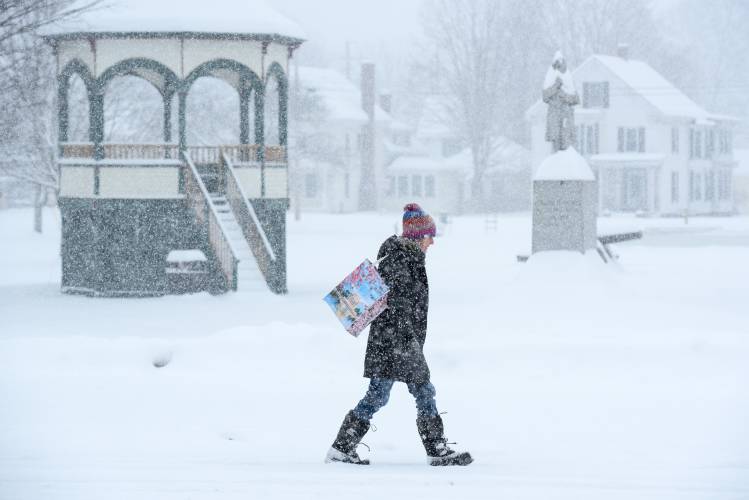 Laura Schieb walks from her South Royalton home to the Post Office to send Easter packages to her kids on Saturday, March 23, 2024. An early spring storm dropped as much as 20 inches of snow over the region. (Valley News - James M. Patterson) Copyright Valley News. May not be reprinted or used online without permission. Send requests to permission@vnews.com.