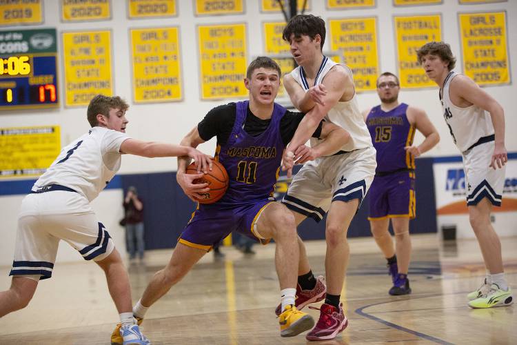 Mascoma forward James Thomas (11) drives toward the basket while being guarded by St. Thomas Aquinas guards Anthony Settineri (3) and James Allen (14) during the NHIAA Division III boys basketball semifinal game against St. Thomas Aquinas High School held at Bow High School in Bow, N.H., on Tuesday, Feb. 20, 2024. (Valley News / Report For America - Alex Driehaus) Copyright Valley News. May not be reprinted or used online without permission. Send requests to permission@vnews.com.