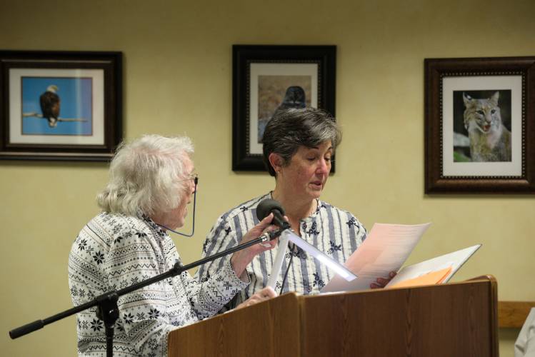 Dorothy Whitney Yamashita, 98, left, reads a poem by  her grandson, Terence Kitada, with her daughter Dana Yamashita, of Troy, N.Y., right, about the experience of Japanese-Americans who were removed from their communities on the West Coast and relocated to concentration camps during World War II, during a talk at Harvest Hill Assisted Living in Lebanon, N.H., on Tuesday, Feb. 20, 2024. After Executive Order 9066, Yamashita’s husband and his family were forced to leave Terminal Island, where they lived and worked in the fishing industry. “The repercussions of that order are never-ending,” said Dorothy Whitney Yamashita. “I keep thinking of more ripples.” (Valley News - James M. Patterson) Copyright Valley News. May not be reprinted or used online without permission. Send requests to permission@vnews.com.
