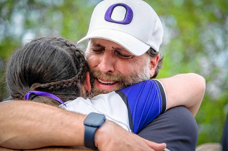 Oxbow coach Chuck Simmons hugs one of his players after the Olympians defeated Thetford during the Vermont Division III state championship in Castleton, Vt., on Saturday, June 10, 2023. (Glenn Russell photograph)