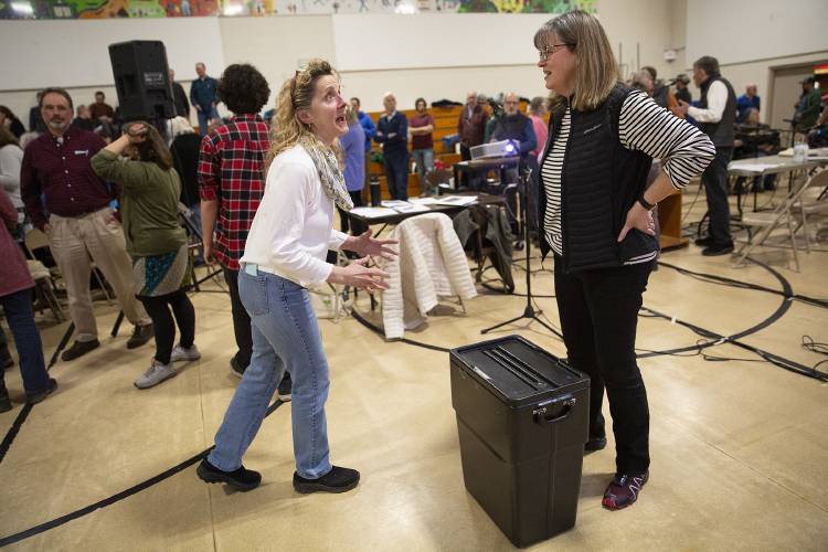 Marcy Marceau, left, talks to Town Clerk Catherine Sartor while voting by paper ballot to elect a school board member to a three-year term during the Annual School Meeting at Sharon Elementary School in Sharon, Vt., on Monday, March 4, 2024. Marceau, nominated by her son Joseph, ran against current board chair Will Davis, who won his reelection 76-12. (Valley News / Report For America - Alex Driehaus) Copyright Valley News. May not be reprinted or used online without permission. Send requests to permission@vnews.com.