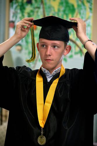 Zach Frary, of South Royalton, Vt., adjusts his mortarboard and tassel as he and his White River Valley High School classmates prepare for their commencement ceremony in South Royalton, Vt., on June 17, 2023. (Valley News - Geoff Hansen) Copyright Valley News. May not be reprinted or used online without permission. Send requests to permission@vnews.com.