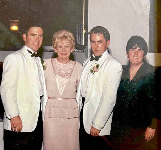 Joyce Conroy flanked by her sons, Brian, left, and Michael. Her daughter, Kathy, is at right as the family celebrates Michael's 1996 wedding.