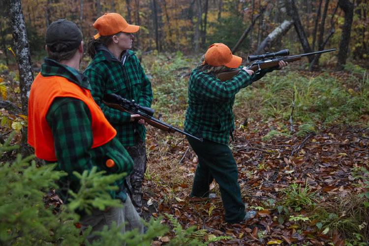 Donna Hill, right, of Thetford, Vt., looks through the scope mounted on her rifle while on a moose hunt with her daughter Katherine Hill, center, and son-in-law Andrew Eaton, both of West Fairlee, Vt., in Victory, Vt., on Saturday, Oct. 21, 2023. Winter ticks and brainworm have contributed to a deterioration in the health of Vermont’s moose population, which has experienced declining birth rates and increased calf mortality. “We’re teetering, which is not a good place to be,” said Nick Fortin, Vermont Fish and Wildlife Department deer and moose project leader. (Valley News / Report For America - Alex Driehaus) Copyright Valley News. May not be reprinted or used online without permission. Send requests to permission@vnews.com.