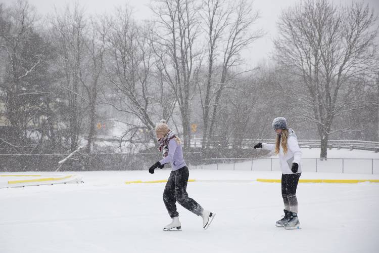 Katherine Herring, left, skates with her sister Madilyn Herring, both of Lebanon, N.H., at Pat Walsh Park in Lebanon on Tuesday, Jan. 16, 2024. The pair showed up to find the rink covered in snow and pitched in to help Lebanon Recreation, Arts and Parks staff shovel before their first skate of the year. (Valley News / Report For America - Alex Driehaus) Copyright Valley News. May not be reprinted or used online without permission. Send requests to permission@vnews.com.