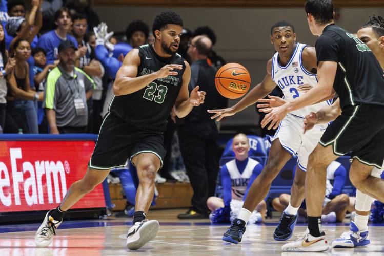 Dartmouth's Robert McRae III (23) takes a pass from Jackson Munro (33) as Duke's Jaylen Blakes (2) defends during the second half of an NCAA college basketball game in Durham, N.C., Monday, Nov. 6, 2023. Men's basketball players for Dartmouth are attempting to unionize, filing a petition with the National Labor Relations Board in September. (AP Photo/Ben McKeown)