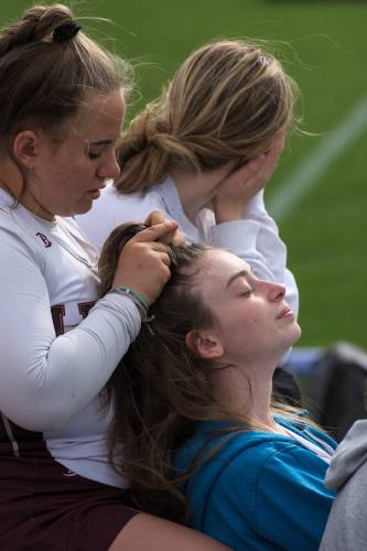 Harper Rancourt, left, braids the hair of her Lebanon junior varsity lacrosse teammate Kaylee Felch, right, before their game with Coe-Brown in Lebanon, N.H., on Friday, April 19, 2024. (Valley News - James M. Patterson) Copyright Valley News. May not be reprinted or used online without permission. Send requests to permission@vnews.com.