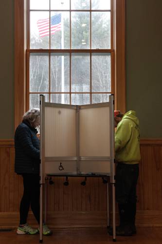 Valerie LaCroix, left, and Will Maginnis, right, fill out their ballots  at Town Hall in Barnard, Vt., on Tuesday, March 5, 2024. Voters in the Mountain Views School District, which includes the Upper Valley towns of Barnard, Bridgewater, Pomfret and Woodstock, rejected a $99 million bond to replace Woodstock Union Middle and High School. (Valley News - James M. Patterson) Copyright Valley News. May not be reprinted or used online without permission. Send requests to permission@vnews.com.