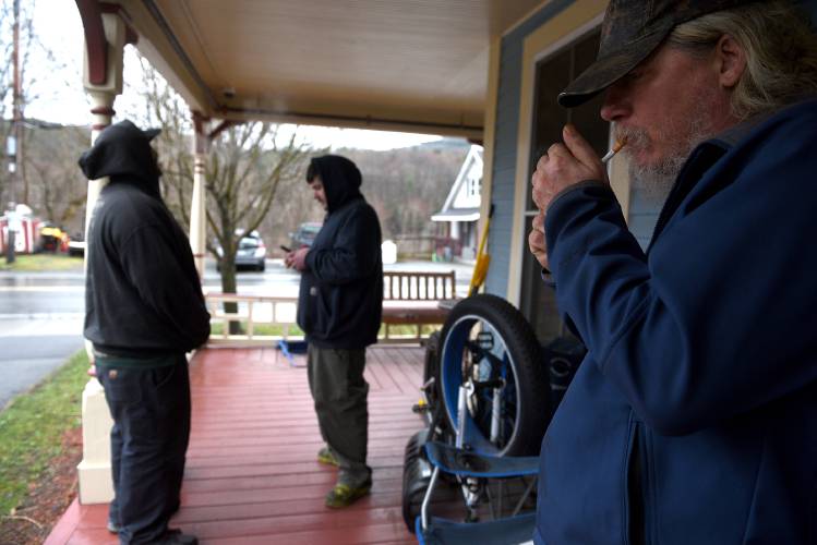 Hartford Dismas House residents A.J. Stone, left, Dana Osmer and David Barnes take a quick smoke break after dinner at the home on Wednesday, April 10, 2024, in Hartford Village, Vt. (Valley News - Jennifer Hauck) Copyright Valley News. May not be reprinted or used online without permission. Send requests to permission@vnews.com.