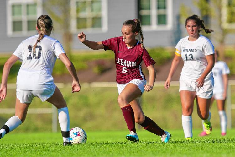 Lebanon High's Annie Hanna (6) dribbles between Milford defenders Jocelyn Shaw (10) and Haleigh Lloyd during the NHIAA Division II teams' Sept. 5, 2023, contest in Lebanon, N.H. Lebanon won, 2-0. (Valley News - Tris Wykes) Copyright Valley News. May not be reprinted or used online without permission. Send requests to permission@vnews.com.