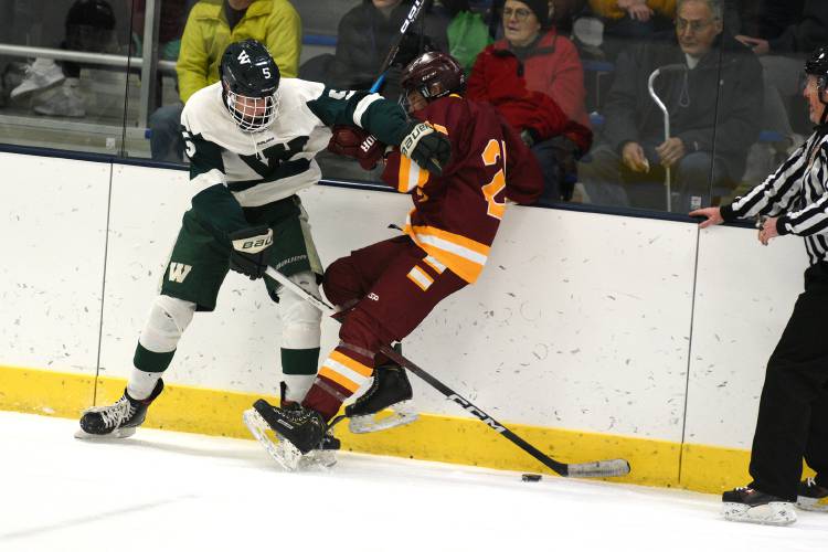 During the Philippe H. Bouthillier Holiday Classic hockey tournament, Woodstock's Kyle Costales and Lebanon's CJ Gogan battle along the boards on Wednesday, Dec. 27, 2023, in White River Junction, Vt. Lebanon won, 4-0. (Valley News - Jennifer Hauck) Copyright Valley News. May not be reprinted or used online without permission. Send requests to permission@vnews.com.