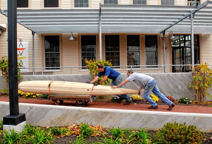 Campton, N.H., artist Phil Lonergan (right) and his friend Ken Morrell, also of Campton, push a large piece of sculpted ash tree into the Alliance for the Visual Arts gallery in Lebanon on Oct. 23, 2007. After an extensive renovation, the art center reopens with two exhibitions, including one which features work created from discarded objects left-over from the H.W. Carter overall factory. (Valley News - Nicholas Richer) Copyright Valley News. May not be reprinted or used online without permission. Send requests to permission@vnews.com.