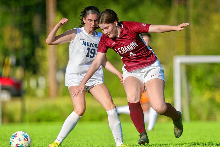 Lebanon High's Sara Forman, right, cuts in front of Milford's Maggie Pelletier during the NHIAA Division II teams' Sept. 5, 2023, contest in Lebanon, N.H. Lebanon won, 2-0. (Valley News - Tris Wykes) Copyright Valley News. May not be reprinted or used online without permission. Send requests to permission@vnews.com.