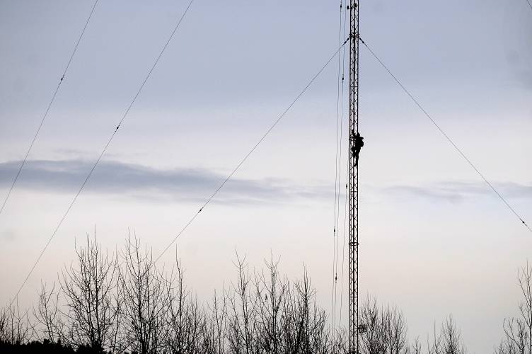A worker climbs the 200-foot tower formerly used by radio stations WNHV-AM, WKXE-AM and WHDQ-FM on the Maxfield property in White River Junction, Vt., on Feb. 14, 2012. The tower was removed to make way for playing fields on the property. (Valley News - Jennifer Hauck) Copyright Valley News. May not be reprinted or used online without permission. Send requests to permission@vnews.com.
