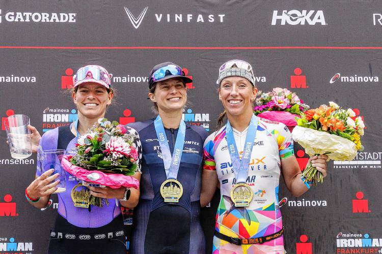 FRANKFURT AM MAIN, GERMANY - JULY 02: (L-R) Skye Moench of the United States of America, Sarah True of the United States of America and Agnieszka Jerzyk of Poland pose for a picture during the flower ceremony of the IRONMAN European Championship Frankfurt on July 02, 2023 in Frankfurt am Main, Germany. (Photo by Jan Hetfleisch/Getty Images for IRONMAN)