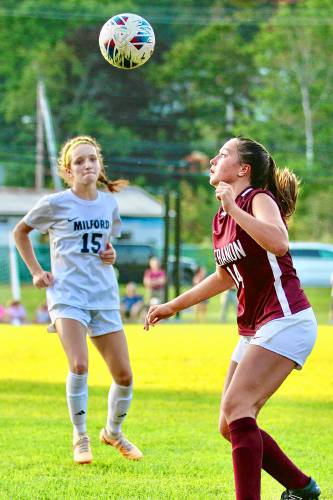 Lebanon High's Brooke Walker, right, and Milford's Lulu Maguire watch the airborne ball during their NHIAA Division II teams' Sept. 5, 2023, contest in Lebanon, N.H. Lebanon won, 2-0. (Valley News - Tris Wykes) Copyright Valley News. May not be reprinted or used online without permission. Send requests to permission@vnews.com.