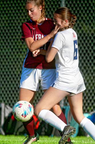 Lebanon High's Abigail Ripley, left, tangles with Merrimack Valley's Grace Corliss during the NHIAA Division II teams' Oct. 2, 2023, game in Lebanon, N.H. Merrimack Valley won, 1-0. (Valley News - Tris Wykes) Copyright Valley News. May not be reprinted or used online without permission. Send requests to permission@vnews.com.