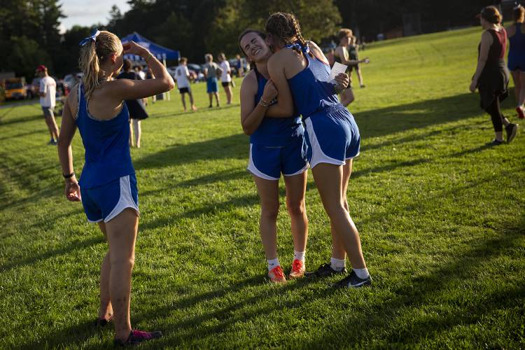 From left, Thetford runners Lucia Carr, Annie Hesser and Ava Hayden celebrate completing their race during a cross country meet at Thetford Academy in Thetford, Vt., on Tuesday, Sept. 12, 2023. (Valley News / Report For America - Alex Driehaus) Copyright Valley News. May not be reprinted or used online without permission. Send requests to permission@vnews.com.