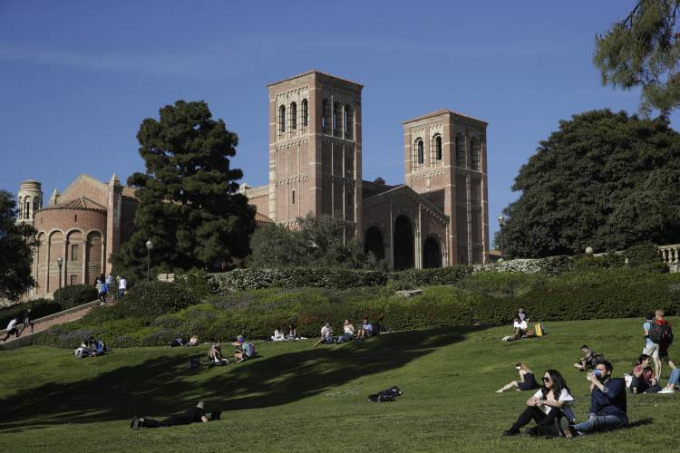 FILE - Students sit on the lawn near Royce Hall at UCLA in the Westwood section of Los Angeles on April 25, 2019. After statewide bans on affirmative action in states from California to Florida, colleges have tried a range of strategies to achieve a diverse student body – giving greater preference to low-income families and admitting top students from communities across their states. But after years of experimentation, some states requiring race-neutral policies have seen drops in...
