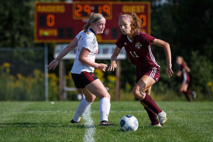Lebanon midfielder Mary Rainey dribbles around Stevens midfielder Jenna Bonneau during a game at Lebanon High School in Lebanon, N.H., on Friday, Aug. 27, 2021. (Valley News / Report For America - Alex Driehaus) Copyright Valley News. May not be reprinted or used online without permission. Send requests to permission@vnews.com.