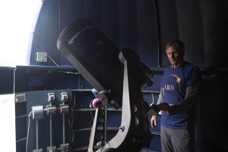 Rob Hanson, co-director of Horizons Observatory, adjusts the angle of the observatory’s telescope at the Prosper Valley School in South Pomfret, Vt., on Wednesday, April 3, 2024. The 14-inch Celestron telescope was donated by Mundy Wilson in 2002, prompting the construction of the observatory, which has created opportunities for students and community members to participate in astronomy research and astrophotography. (Valley News / Report For America - Alex Driehaus) Copyright Valley News. May not be reprinted or used online without permission. Send requests to permission@vnews.com.