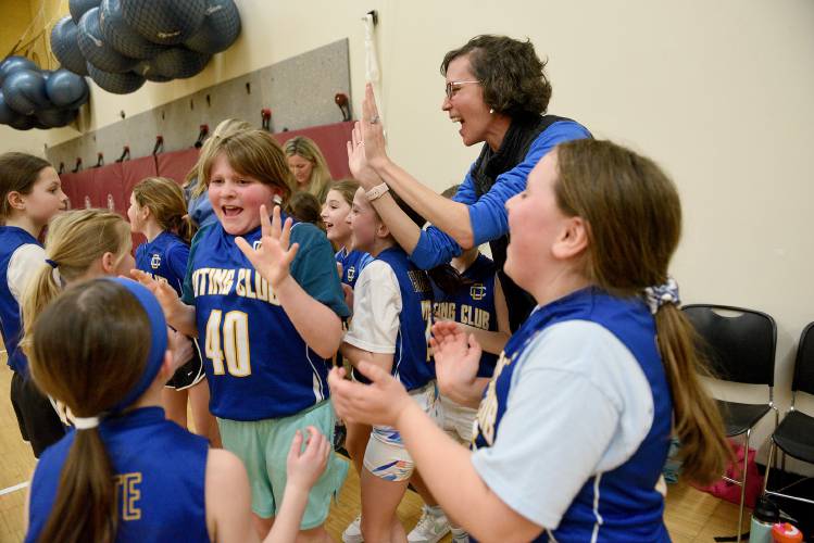 The New London Outing Club girls third- and fourth-grade basketball team celebrates their close win at the Karp’s Klassic on Thursday, March 14, 2024, in Lebanon, N.H. Players Piper Cote, Ryleigh Turcotte and Addie Stone react with assistant Beth Hansen. (Valley News - Jennifer Hauck) Copyright Valley News. May not be reprinted or used online without permission. Send requests to permission@vnews.com.