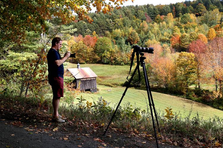 Jim Kibbe, of Greenwich, Conn., photographs a farm along Cloudland Road in Pomfret, Vt., on Sept. 29, 2020. Following COVID-19 protocols,  Kibbe and his wife are on a week-long trip to see the leaves in Maine and Vermont as he is between jobs. 