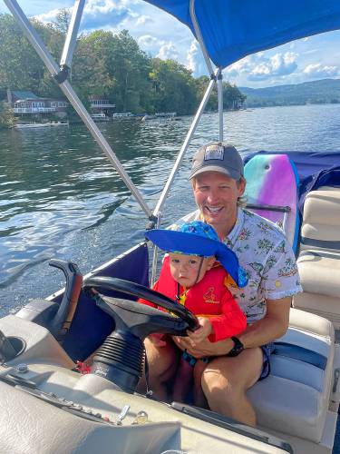 Chris Bustard with his son Teddy on Pleasant Lake in Elkins, N.H., in Sept. 2022. (Elizabeth Mitchell photograph)