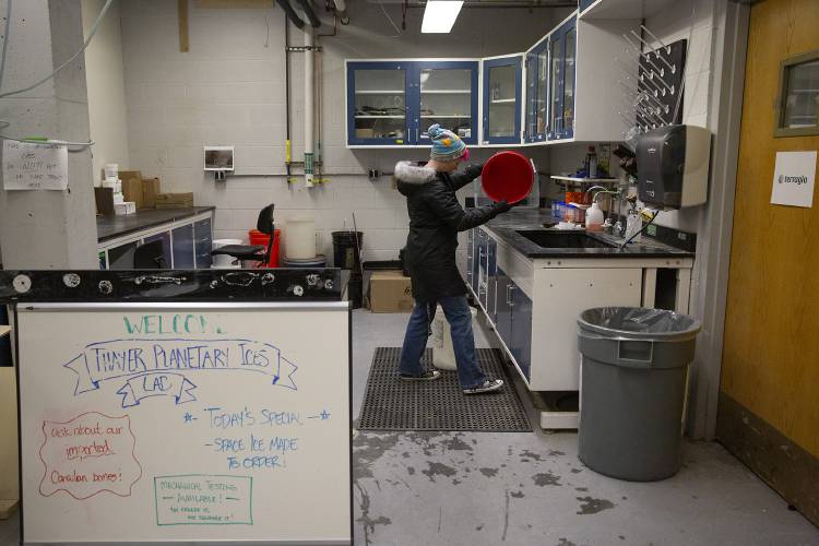 Tara Tomlinson, a third-year PhD student, cleans up her lab space after mixing a brine that will be frozen to mimic the chemical composition of the ice found on Europa, Jupiter’s fourth-largest moon, at Dartmouth’s Thayer School of Engineering in Hanover, N.H., on Tuesday, April 2, 2024. While her work isn’t directly related to eclipses, Tomlinson said that when it comes to astronomy, “it’s sort of all connected,” noting that every atom and molecule in existence was once part of a star. (Valley News / Report For America - Alex Driehaus) Copyright Valley News. May not be reprinted or used online without permission. Send requests to permission@vnews.com.