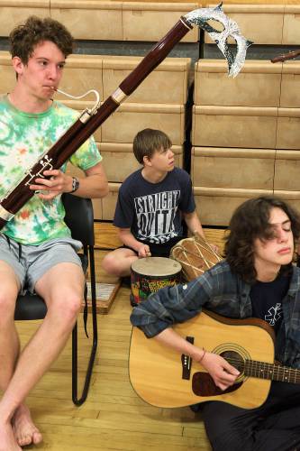 Silas Adkins-Hooke, 17, left, Sage Mills, 15, middle, and Seamus Hogan, 14, right, provide music for the masked ball during a rehearsal for Much Ado About Nothing at the Chelsea, Vt., school, on Tuesday, July 18, 2023. (Valley News - James M. Patterson) Copyright Valley News. May not be reprinted or used online without permission. Send requests to permission@vnews.com.