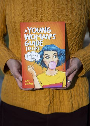 Ann Aikens holds a copy of her book “A Young Woman’s Guide to Life” in Bethel, Vt., on Tuesday, Oct. 31, 2023. (Valley News / Report For America - Alex Driehaus) Copyright Valley News. May not be reprinted or used online without permission. Send requests to permission@vnews.com.