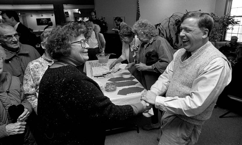 Marge Bussone of Windsor, Vt., congratulates longtime Upper Valley radio host Ray Reed at a celebration of Ray Reed Day at the Bugbee Senior Center in White River Junction, Vt., on Dec. 9, 1992. Reed hosted a popular AM radio show for nearly 20 years before his job was eliminated due to cost-cutting technology. (Valley News - Robert Pope) Copyright Valley News. May not be reprinted or used online without permission. Send requests to permission@vnews.com.
