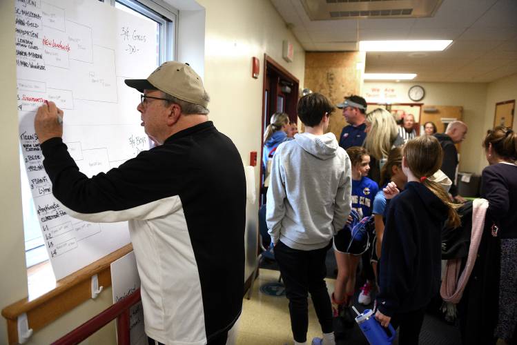 Paul Karp records the results of a girls third- and fourth-grade basketball game at the Karp’s Klassic on Thursday, March 14, 2024, in Lebanon, N.H. (Valley News - Jennifer Hauck) Copyright Valley News. May not be reprinted or used online without permission. Send requests to permission@vnews.com.