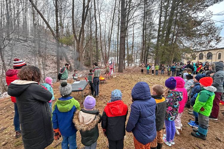 On snowy March 20, 2024, at 7:50 a.m., Brownsville Trail Life Troop 0316 demonstrated for Albert Bridge School students the proper and respectful way to retire an American flag in West Windsor, Vt. The ceremony took place at the fire pit adjacent to the Brownsville Community Church and its pavilion in Tribute Park. (Linda Ley photograph)