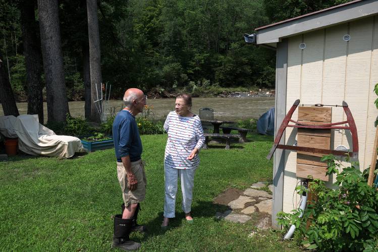 Al Pristaw, 80, left, and his partner Pauline Holt, 82, returned to the Riverside Mobile Home Park in Woodstock, Vt., to find their home intact on Tuesday, July 11, 2023, after being evacuated on Monday due to rising floodwaters on the Ottauquechee River. The couple fared worse during Irene, losing a vehicle in the 2011 flood. (Valley News - James M. Patterson) Copyright Valley News. May not be reprinted or used online without permission. Send requests to permission@vnews.com.