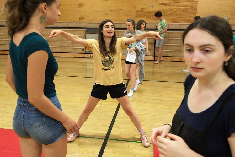 Tess Holbrook, head director at the Chelsea Funnery, tells the theater camp’s participants, including Sophie Sevi, 17, of Montpelier, left, and staff, including Lukina Andreyev, of Tivoli, N.Y., right, how to set up their temporary stage for a run through of Much Ado About Nothing at the Chelsea, Vt., school, on Tuesday, July 18, 2023. The camp takes participants from an initial reading of a play’s script over the first two days through to a final performance in only two weeks. (Valley News - James M. Patterson) Copyright Valley News. May not be reprinted or used online without permission. Send requests to permission@vnews.com.