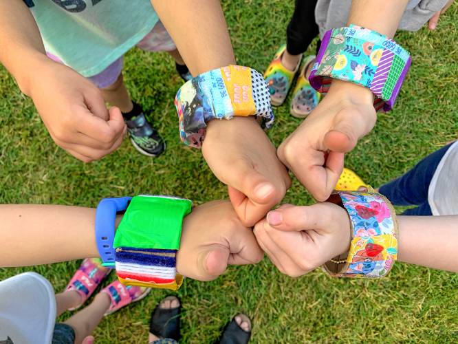 Children show off bracelets they created with rePlay Arts during the Hartford Community Coalition's annual Block Party in June. (rePlay Arts photograph)
