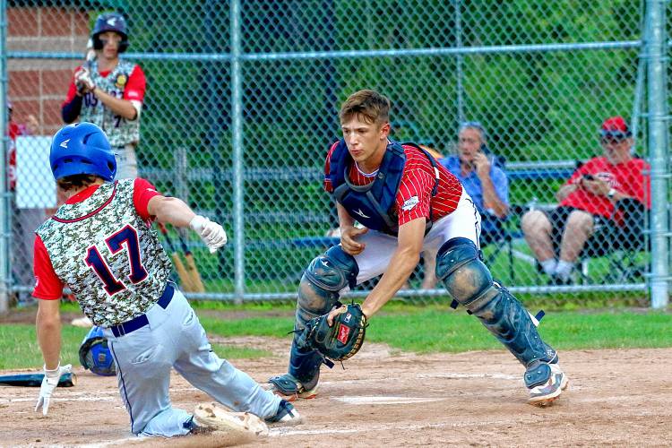 White River Junction Post 84 catcher Zach Johnson tags out Lebanon Post 22 runner Zander Doyle during the American Legion senior baseball teams' July 19, 2023, exhibition game at the Maxfield Sports Complex in White River Junction, Vt. Post 22 won, 10-9. (Valley News - Tris Wykes) Copyright Valley News. May not be reprinted or used online without permission. Send requests to permission@vnews.com.