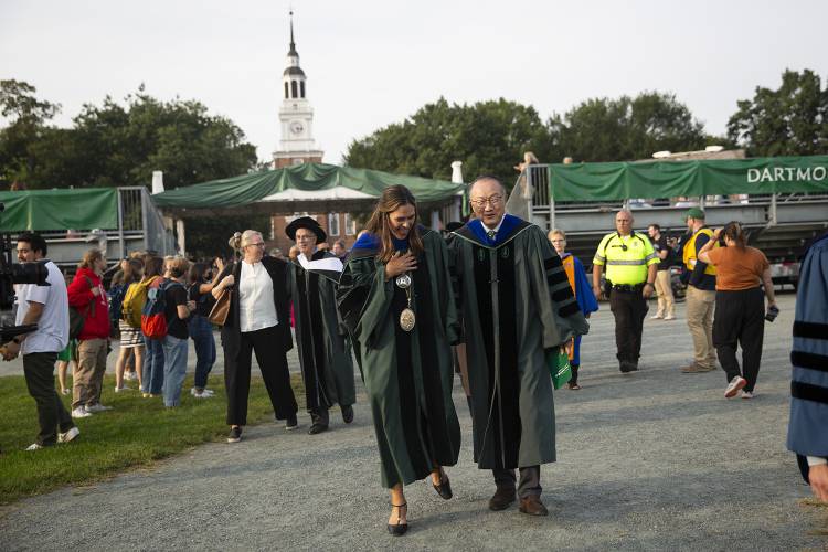 Dartmouth President Sian Leah Beilock, left, laughs while walking with former Dartmouth President Jim Yong Kim as they leave Beilock’s inauguration ceremony held on the green in Hanover, N.H., on Friday, Sept. 22, 2023. During her speech Beilock laid out her vision for her time at Dartmouth including goals of expanding housing for students and staff, creating “brave spaces” to help students meaningfully engage in difficult discussions, and investing in attaining true carbon neutrality on campus. (Valley News / Report For America - Alex Driehaus) Copyright Valley News. May not be reprinted or used online without permission. Send requests to permission@vnews.com.