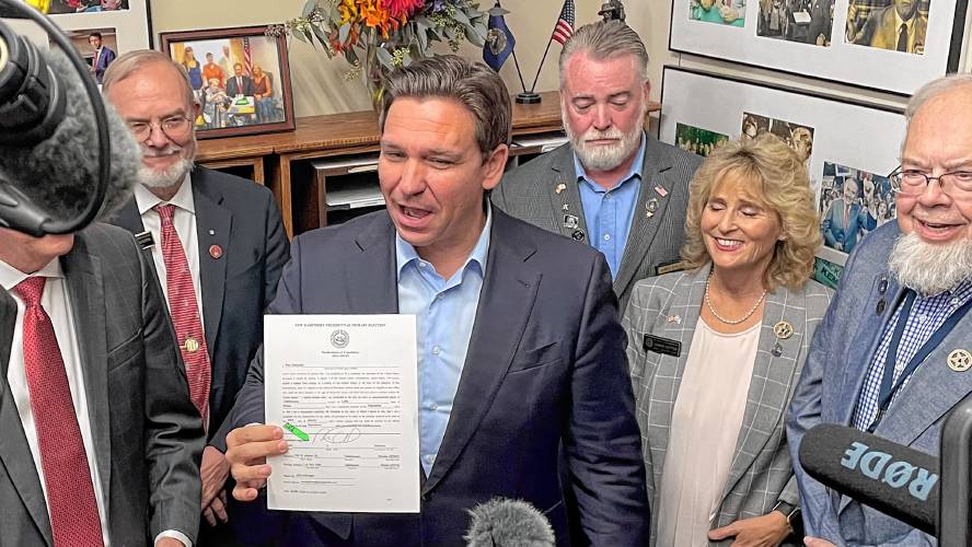 Ron DeSantis shows his paperwork to file to run in the New Hampshire Republican Primary at the Secretary of State's office Thursday. 