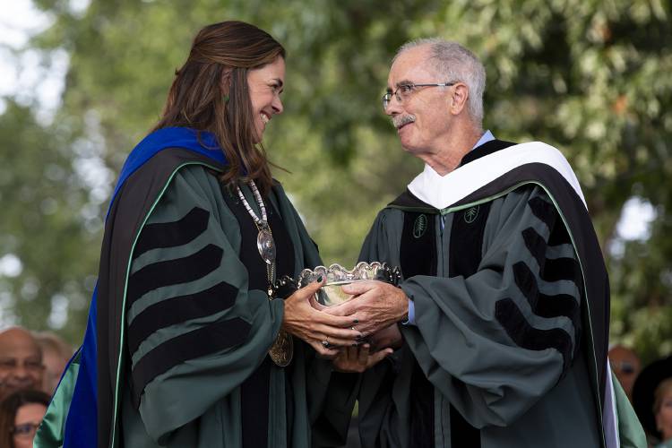 Former Dartmouth President Philip Hanlon, right, hands the Wentworth Bowl to his successor Sian Leah Beilock during her inauguration as the 19th President of Dartmouth College in Hanover, N.H., on Friday, Sept. 22, 2023. The bowl was originally given to Dartmouth founder Eleazar Wheelock by John Wentworth, royal governor of the province of New Hampshire, in 1773 and has since become a symbol of the institution that is passed down between presidents. (Valley News / Report For America - Alex Driehaus) Copyright Valley News. May not be reprinted or used online without permission. Send requests to permission@vnews.com.
