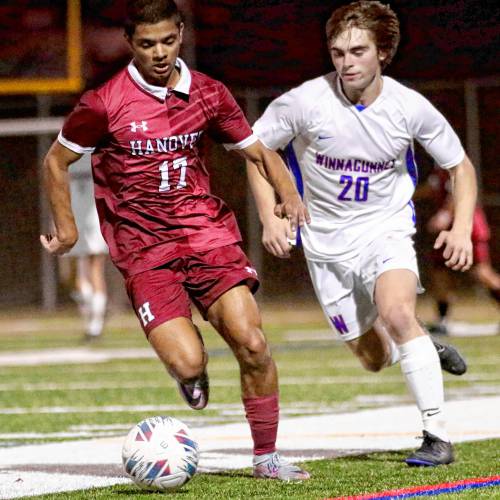 Hanover HIgh's Veer Patel (17) dribbles alongside Winnacunnet's Ben Mace during the NHIAA Division I teams' playoff quarterfinal game on Oct. 27, 2023, at Merriman-Branch Field in Hanover, N.H. Hanover won, 5-1. (Valley News - Tris Wykes) Copyright Valley News. May not be reprinted or used online without permission. Send requests to permission@vnews.com.